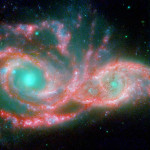These shape-shifting galaxies have taken on the form of a giant mask. The icy blue eyes are actually the cores of two merging galaxies, called NGC 2207 and IC 2163, and the mask is their spiral arms. The false-colored image consists of infrared data from